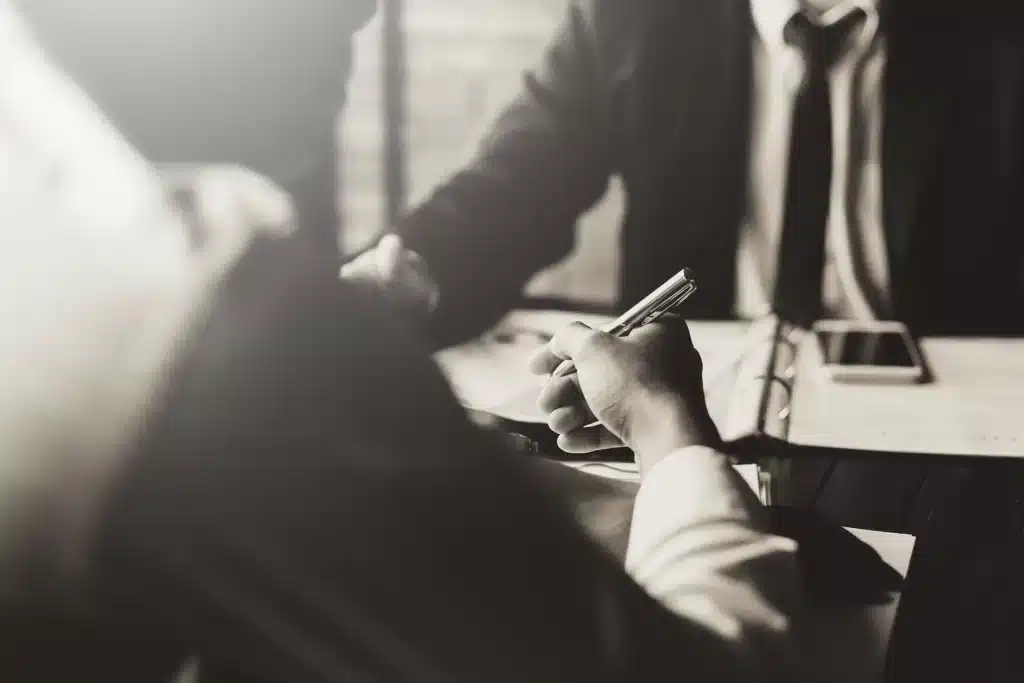 An attorney speaking with their client at the desk.