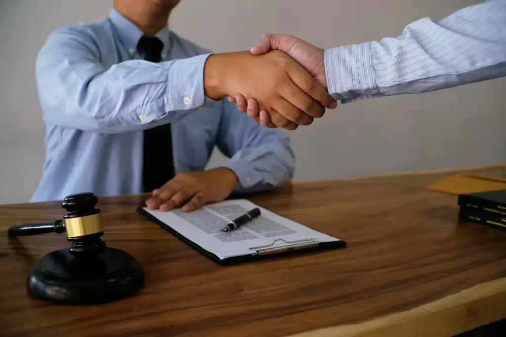A lawyer and client shaking hands.